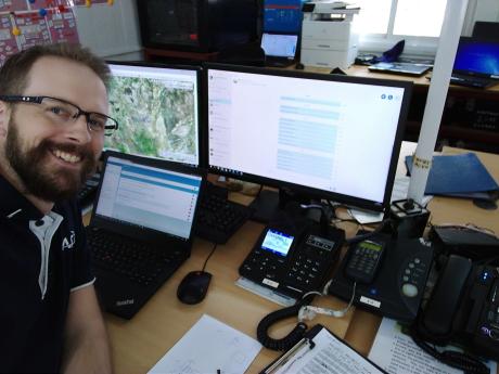 Man at computer looking into camera