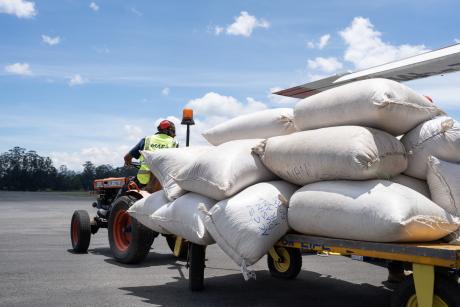 sacks of coffee beans on a trolley unloaded of a flight from a remote community