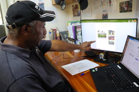 Teaching volunteer at the Salem Jacob Dinoke, working on a Desktop.