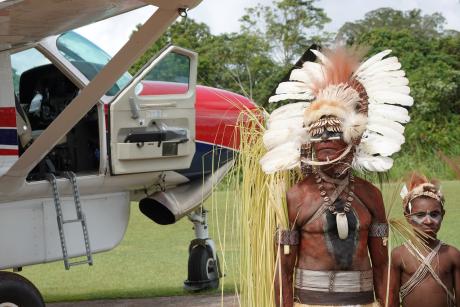 greeting the MAF plane with traditional dancing