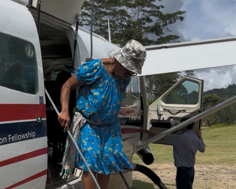 Mama Pokome exiting a MAF aircraft