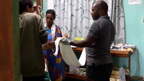 Paul Isilawa assisting in the delivery room