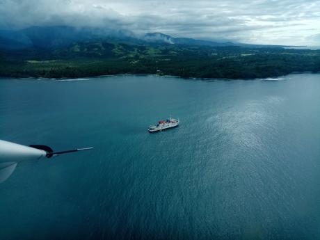 overhead the coast of Saidor with the YWAM medical ship anchored off shore