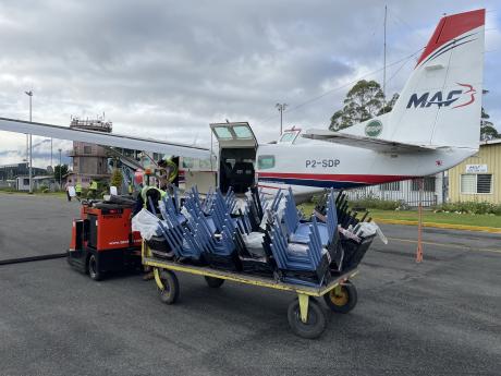 2-SDP Mt Hagen with cargo trolley full of new chairs for Mougulu Sec School