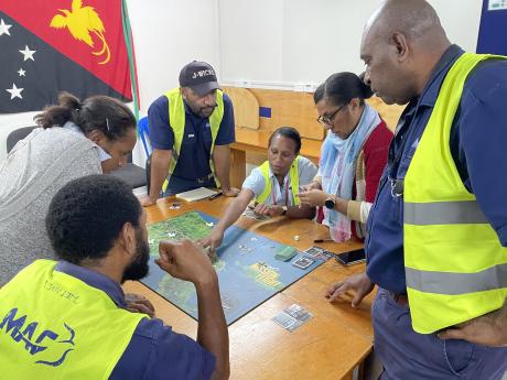 staff playing the Mission Flight Board game