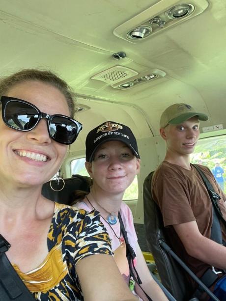Melissa and her two kids in the MAF plane
