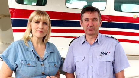 Helen and Andy Symmonds in front of a MAF plane.