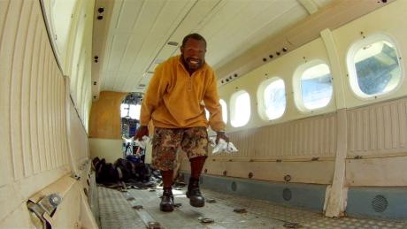 A man smiling in an aeroplane cabin