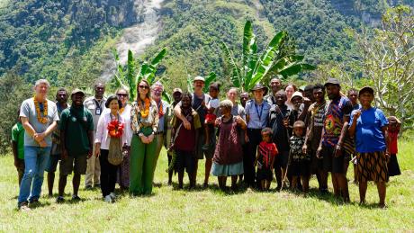 A group of people pose for a photo on an airstrip