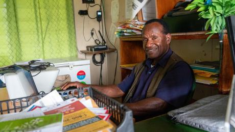 A man sit in the office smiling