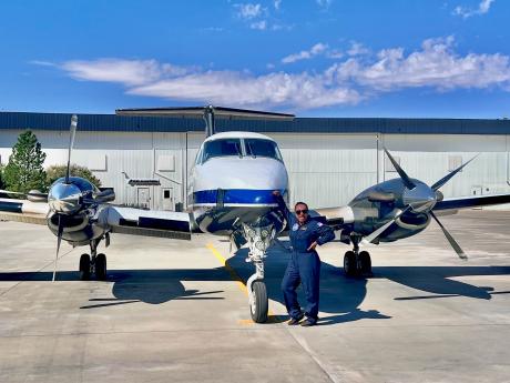 Esther Dii standing in frong of the aircraft she pilots