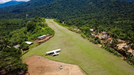 Aerial view of a MAF plane at remote Yambaitok airstrip