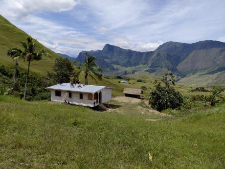 Men installing the Vaccine Fridges and solar panels at Ambi