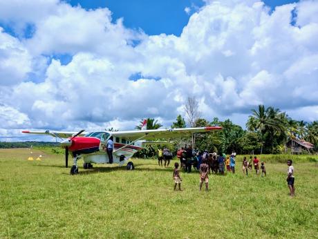 Ricky Poki with an MAF plane at a remote airstrip.